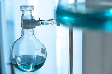 Round bottom flask with green liquid.