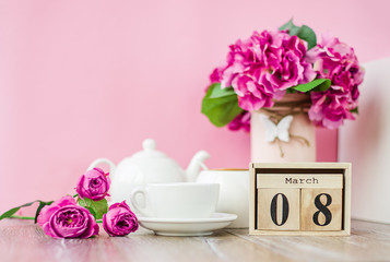 Women's Day. March 8 tree calendar, International Women's Day, decorated with pink and purple flowers on a pink background.