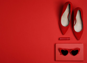 Flat lay composition with stylish women's shoes on red background. Space for text