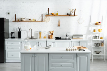 interior of kitchen with cooking utensils, food, milk and kitchenware