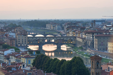 Fototapeta na wymiar Panoramic view of famous Ponte Vecchio bridge with river Arno at sunset in Florence, Italy.