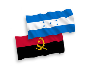 National vector fabric wave flags of Angola and Honduras isolated on white background. 1 to 2 proportion.