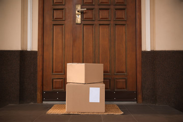 Delivered parcels on door mat near entrance