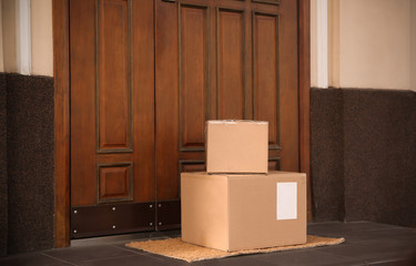 Delivered parcels on door mat near entrance