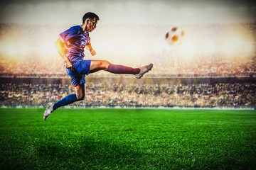 soccer player jumping and kicking the ball in the stadium