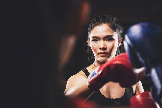 Two Asian Women Doing Practice Boxing Together At The Health Club