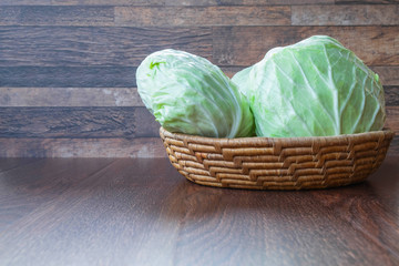 Cabbage in a basket on a wooden table