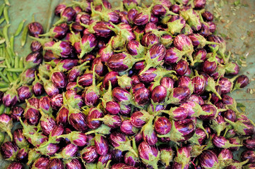 Eggplant on the market, a large pile, close-up. Asian street market of vegetables, the harvest of...