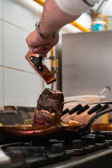 Basting t-bone with melted butter