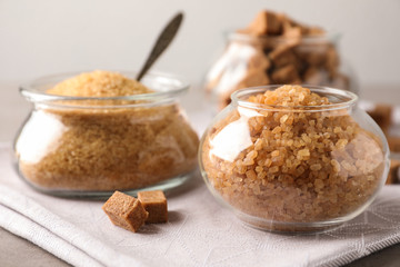 Glass bowls with brown sugar on table
