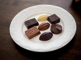 白いお皿の上に並べられた様々な種類のチョコレート