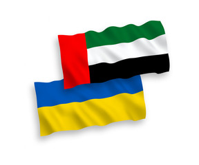 National vector fabric wave flags of United Arab Emirates and Ukraine isolated on white background. 1 to 2 proportion.