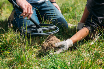 Metal detector searching for treasure in the ground.