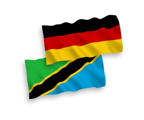 National vector fabric wave flags of Germany and Tanzania isolated on white background. 1 to 2 proportion.