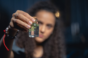 Young woman with a vial of potion
