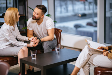 family concept. lovely caucasian married couple visit professional family psychologist every month, expert help them to overcome difficulties in relationships and discuss issues of the day