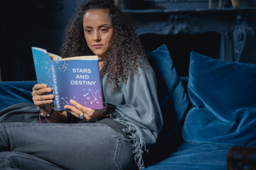 Serious girl acquiring new knowledge at home