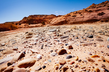 Rocks and sand on the dry river bed in the Utah desert near the Zebra spot Canyon, USA