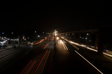 Speed Traffic light trails on highway, long exposure, urban background and dark sky