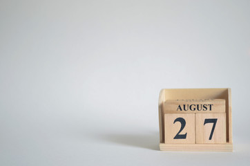 August 27, Empty white background with number cube on the table.