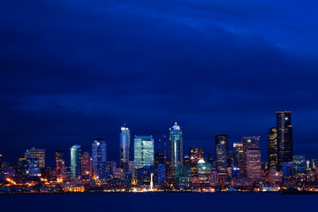 Panorama of Seattle city night downtown view skyline over Elliot bay, WA, USA