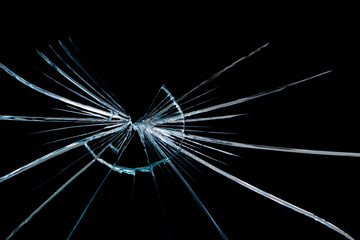 crack in the form of abstraction on broken glass mirror on a black background