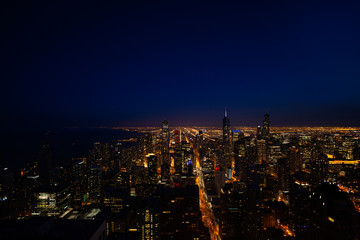 Fototapeta na wymiar Night panorama skyline view of streets and tall skyscrapers of Chicago from above