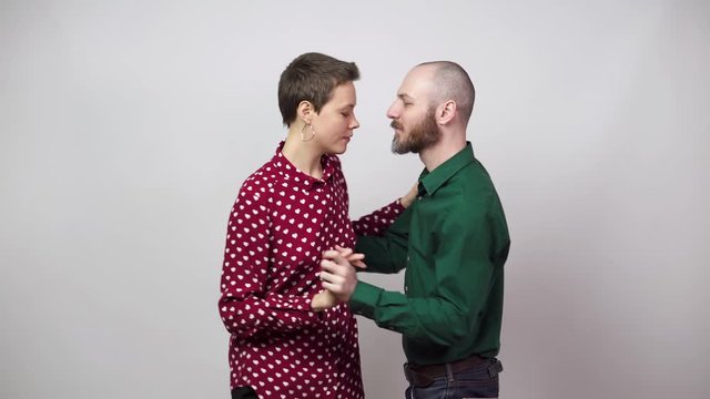 Romantic couple dancing on white background. Man and woman are dancing slow blues dance. Sensual couple dancing.