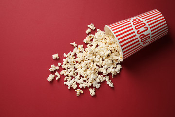 Delicious popcorn on red background, above view