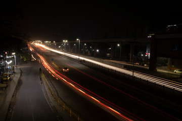 Fototapeta na wymiar Speed Traffic light trails on highway, long exposure, urban background and dark sky