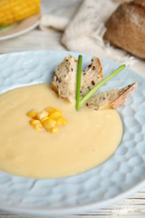 Delicious corn cream soup in bowl, closeup