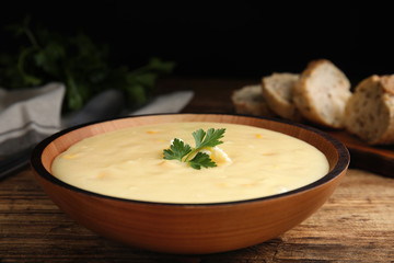 Delicious corn cream soup served on wooden table