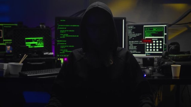 young woman hacker in dark room creating code