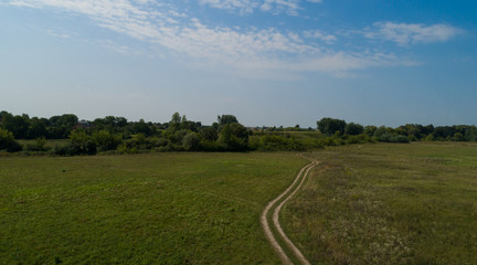 Amazing background. field background. road in the field. Picturesque landscape