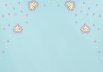 Two hearts made of pink and yellow pills on light blue background. Seasonal diseases. Medicine concept. Flat lay style with copy space, top view.