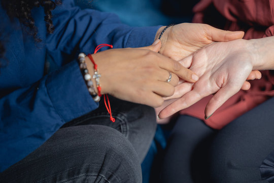Female chiromancer reading her clients palm lines