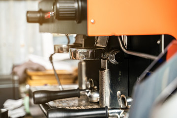 Prepares espresso machine brewing a coffee in coffee shop