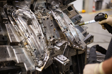 Engineer freezing injection mold after production by dry nitrogen, industrial concept