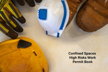 Safe workplace tope picture of confined spaces high risk work permit book with defocused personal...