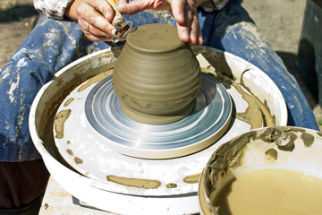 PETROZAVODSK,RUSSIA-JUNE 29TH,2019:The hands of a man who sits at the potter's wheel and works with a clay product