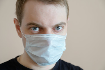 Young man wearing protective medical mask. Selective focus.
