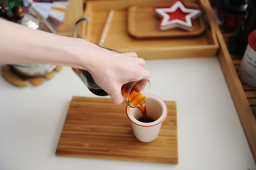 Manual brewing still life. Pouring filter coffee from decanter into cup. Bamboo board. Third wave...