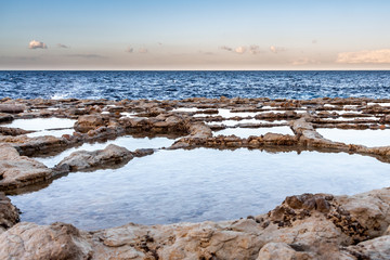 Fantastic view opens to the natural salt stone baths and the Mediterranean Sea in Italy