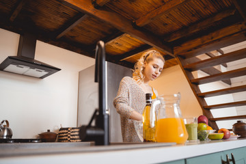 Kind blonde woman spending her time on kitchen