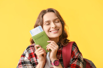 Beautiful female tourist on color background