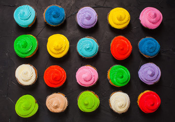 Many delicious sweet cupcakes of different colors