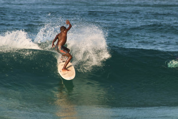 native black african surfer catching a wave