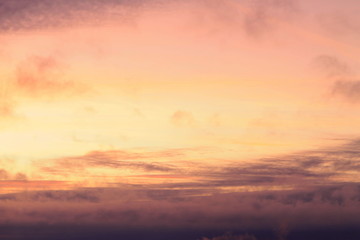 A beautifully backlit colorful sunset sky with the colors of sunrise and sunset.