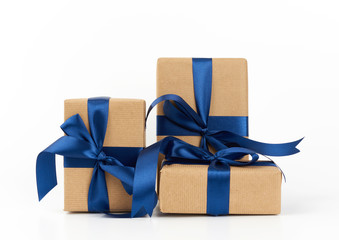 rectangle box wrapped in brown kraft paper and tied with a silk blue ribbon