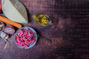 Sauerkraut in a blue bowl on a wooden table. During fermentation, beneficial bacteria provide great...